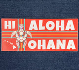 A bumper sticker with a red background featuring the text 'HI ALOHA OHANA' with a graphic of a turtle and Hawaiian flag colors.