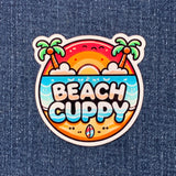 A colorful vinyl decal with the text 'BEACH CUPPY' surrounded by an illustration of palm trees, sun and beach-themed elements.