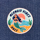 Sticker with a mermaid design and 'Mermaid Vibes Only' text on a denim background