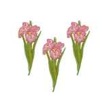 Three embroidered floral patches featuring pink flowers with green stems and leaves, arranged on a plain white background.