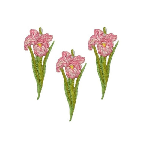 Three embroidered floral patches featuring pink flowers with green stems and leaves, arranged on a plain white background.