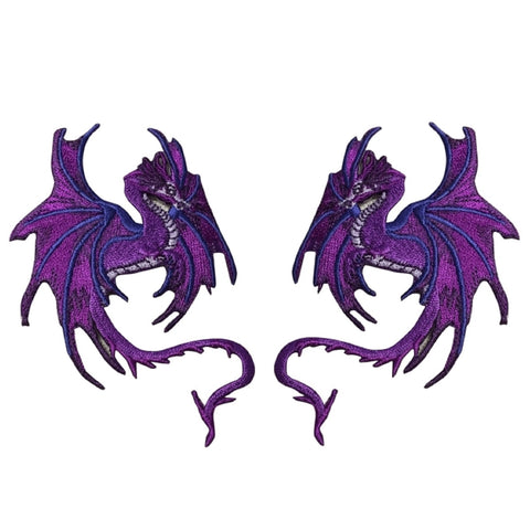 A pair of purple dragon-shaped embroidered patches on a plain white background.