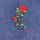 Embroidered red rose patch on denim fabric