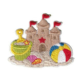 Embroidered patch of a sandcastle with beach toys on a white background