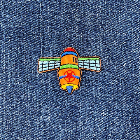 Colorful satellite patch on a denim background