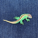 Green lizard-shaped patch on a blue denim background