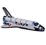 an embroidered space shuttle patch on a white background