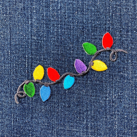 Colorful string lights patch on denim fabric