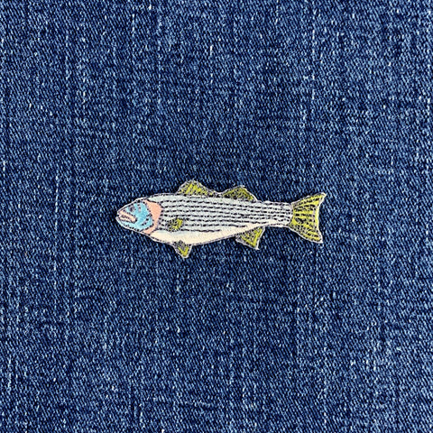 striped bass fish patch on a denim background