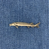 embroidered sturgeon fish patch on a denim background
