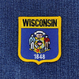 Wisconsin state patch with emblem and text on a denim background