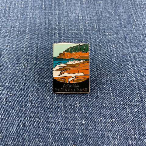 Pin with a scenic design of Acadia National Park on a denim background