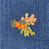 acorns and oak leaves patch on a denim background