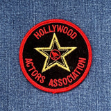 A collectible patch from Hollywood Actors Association featuring a stylized Hollywood logo with red, black, and gold colors on a denim background