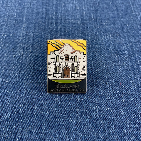 Pin with Alamo San Antonio design on a denim background