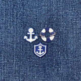 3 Embroidered nautical design patches on denim fabric with an anchor, life buoy, and shield.
