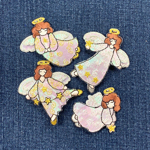 Set of four angel patches with star accents on a denim background