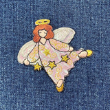 Embroidered angel patch on denim fabric