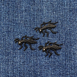 Three black ant-shaped patches on a blue denim background
