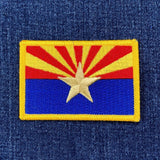 Embroidered patch of the Arizona state flag on denim fabric.