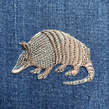 Embroidered armadillo patch on denim fabric