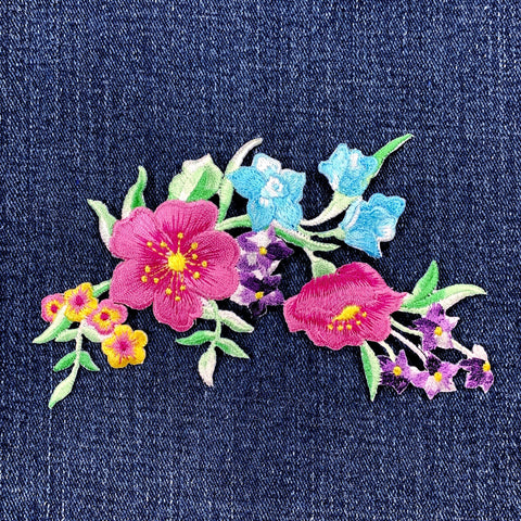Colorful floral embroidery patch on denim fabric