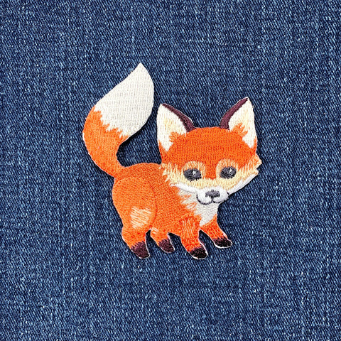 Embroidered fox patch on denim fabric