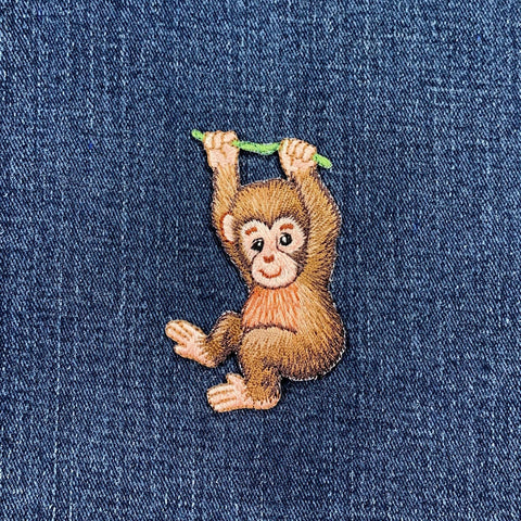 Embroidered monkey patch on denim fabric