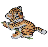 Embroidered patch of a tiger cub sitting on a vine.