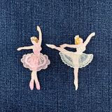 Two ballerina patches on a denim background