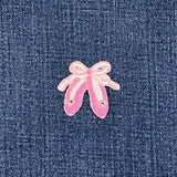 Pink ballet slippers patch on denim fabric