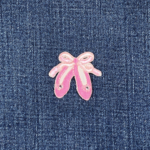 Pink ballet slippers patch on denim fabric