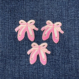 Three pink ballet slipper patches on a denim background