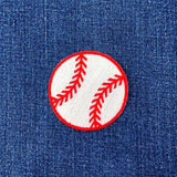 Baseball patch with red stitching on a blue denim background