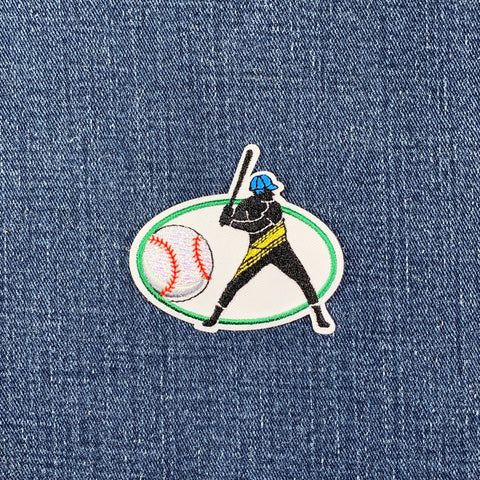 Embroidered patch of a baseball player on a denim background