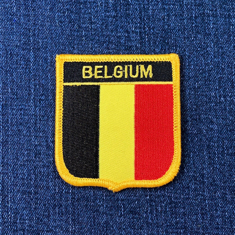 Belgium flag patch on a blue fabric background