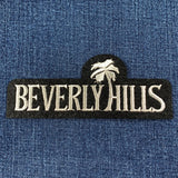 Embroidered 'Beverly Hills' patch on a blue denim background