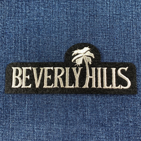 Embroidered 'Beverly Hills' patch on a blue denim background