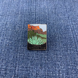 Pin with a Big Bend National Park landscape design on a blue denim background