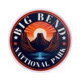 A round vinyl decal featuring a stylized sunset with mountains and the text 'BIG BEND NATIONAL PARK'.