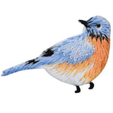 Colorful bird patch with blue, orange, and black feathers on a white background
