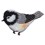 Embroidered patch of a bird with black, white, and orange colors on a white background