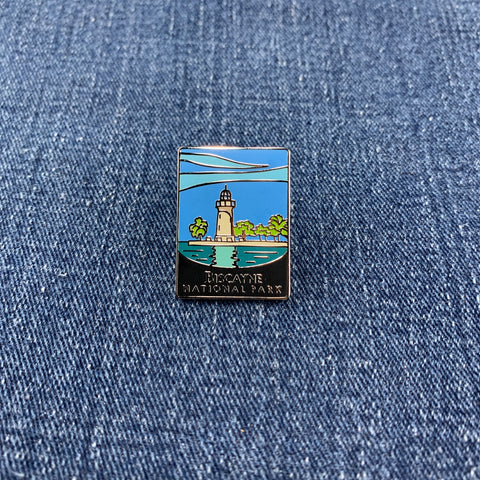 Pin with a Biscayne National Park lighthouse design on a denim background