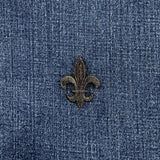 Black embroidered fleur-de-lis patch on a denim background