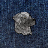 Embroidered black Labrador dog patch on denim fabric
