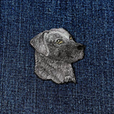 Embroidered dog patch on denim fabric