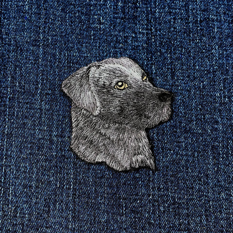 Embroidered black Labrador dog patch on denim fabric