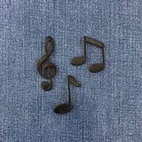 Music notes patches on a denim fabric background
