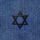 black star of David patch on a denim background