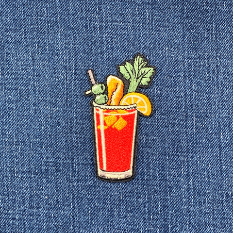 Embroidered patch of a Bloody Mary on denim fabric
